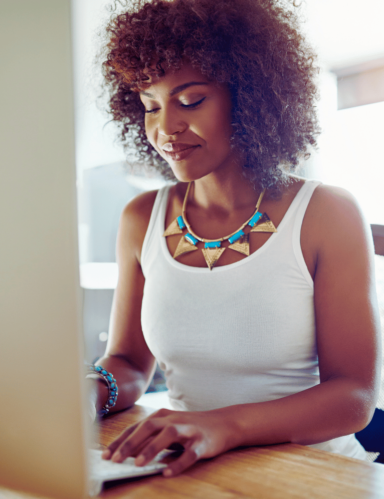 Woman using a laptop with a bright background